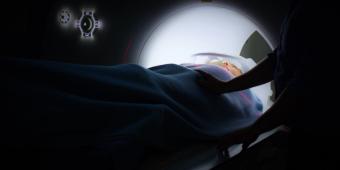 A woman lying down as she is entering the fMRI scanner
